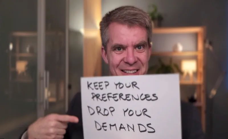 Benjamin holding up a sign saying keep your preferences drop your demands